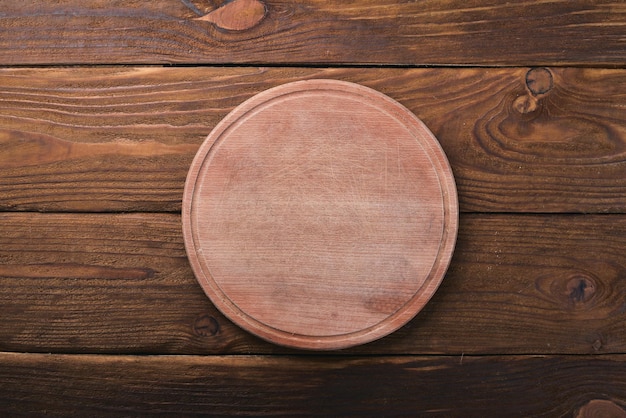 Kitchen wooden board On a wooden background Top view Free space for your text