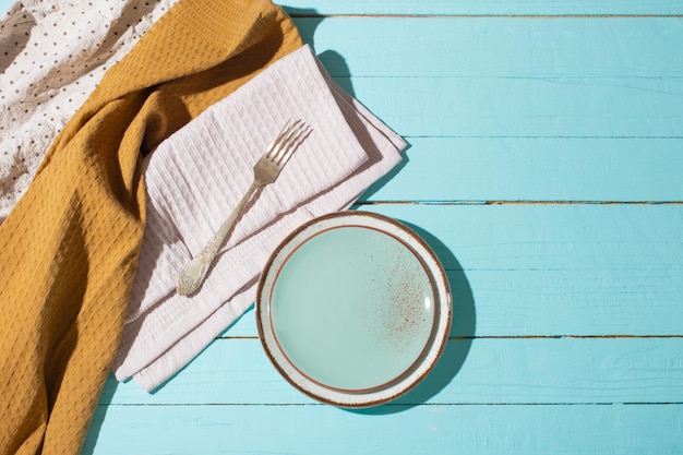 kitchenware on blue wooden table in sunlight