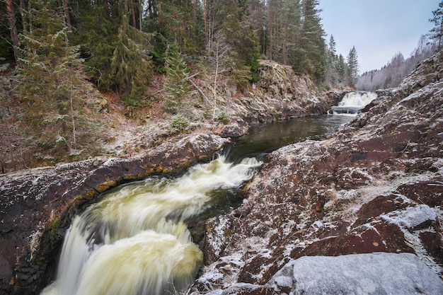 Kivach Kivatsu is a waterfall on the Suna River in the Republic of Karelia Autumn or winter waterfall