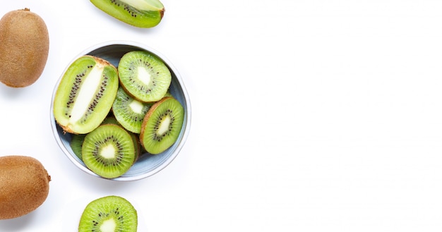 Kiwi fruit with a slice isolated on white.