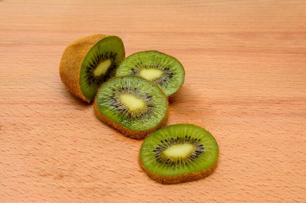 Kiwi fruits on brown wooden background