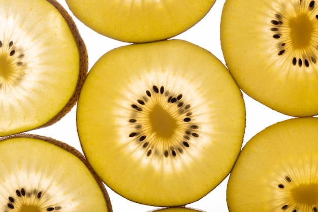 Kiwi Gold fruit background Yellow kiwi slices with black seeds closeup