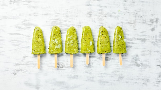 Kiwi Ice Cream Popsicle Top view On a stone background