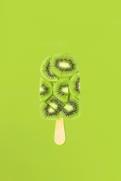 Kiwi ice cream on a stick with kiwi slices on it