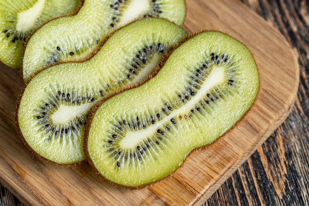 Kiwi slices cut with a knife on a board