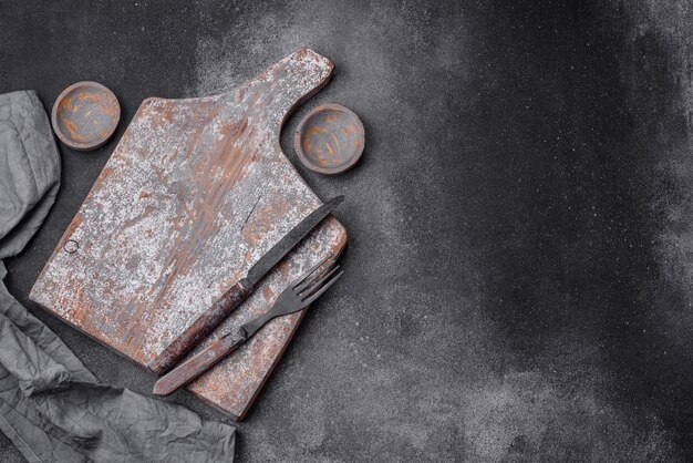 Knife fork and cutting board salt pepper and other ingredients