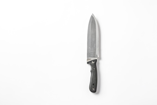 A knife with a reverse blade on a white background