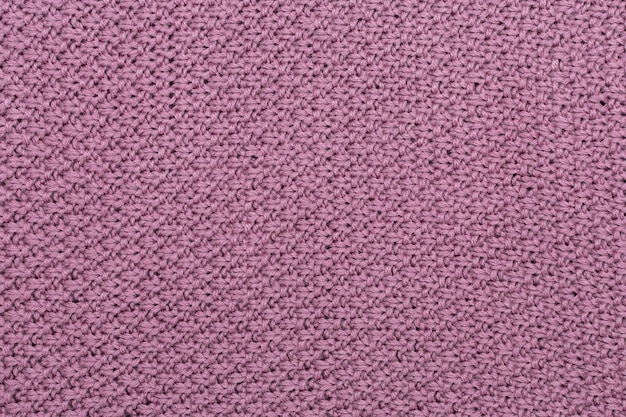 Knitted fabric pearl woolen background The structure of the fabric with a natural texture Fabric background Knitted woolen background