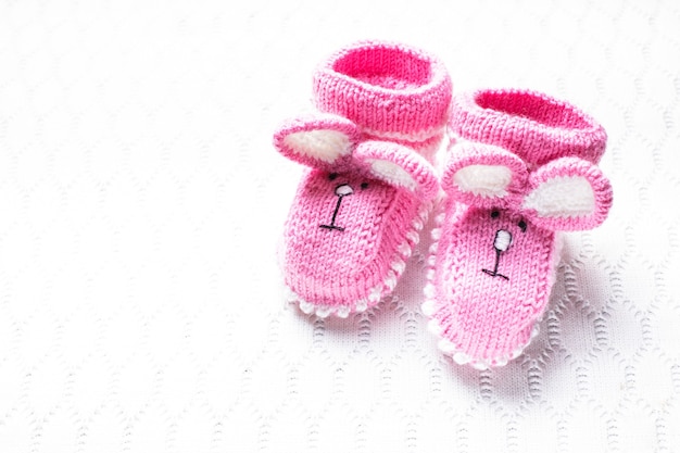 Photo knitted pink baby booties and blanket for little girl