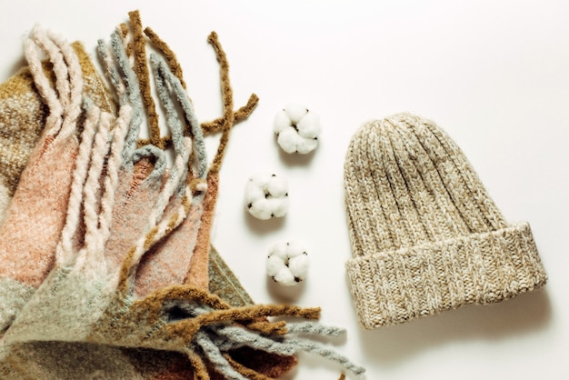 Knitted scarf and hat. Warm winter clothes. Top view, flat lay.