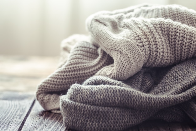 Knitted sweater on a wooden table