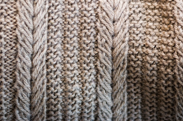 Knitted texture. Pattern fabric made of wool. Background, copy space