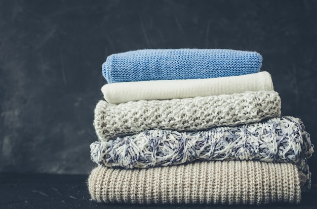 Knitted woolen sweaters on the table