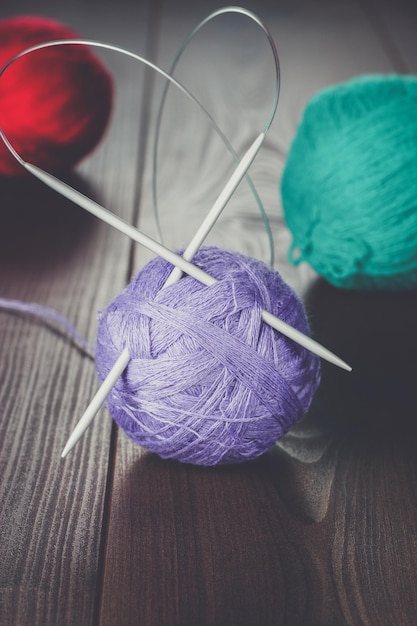 Knitting needles and balls of threads