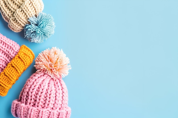 Photo knittted hats on pastel blue background