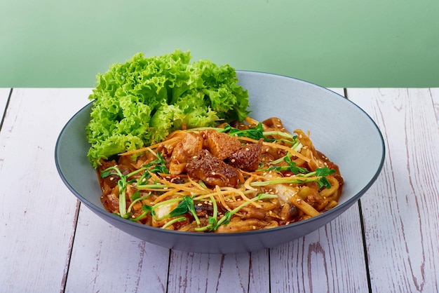 Korean food Udon Bulgogi Lion Mane in a bowl on wood table background