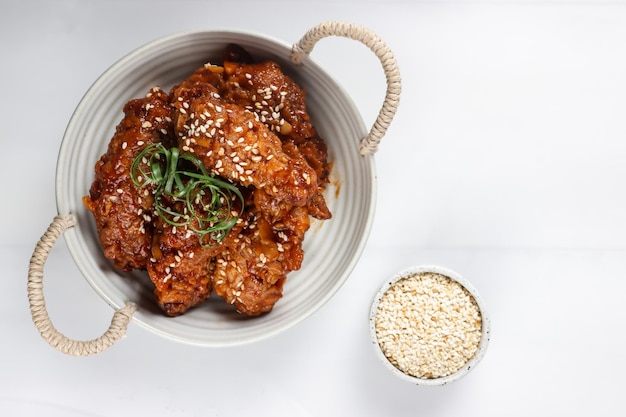 Korean Fried Chicken Yangnyeom Tongdak with Spicy Sauce and Sesame Seed. Sayap ayam pedas Korea.