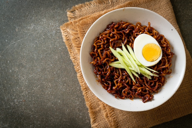 Korean Instant Noodle with Black Bean Sauce topped cucumber and boiled egg (Jajangmyeon or JJajangmyeon) - Korean food style