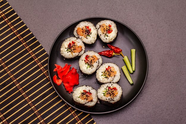 Korean roll Gimbap(kimbob). Steamed white rice (bap) and various other ingredients. Trendy black background