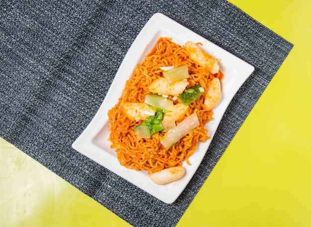 Korean Spicy StirFried Instant Noodles served in bowl isolated on table top view of taiwan food