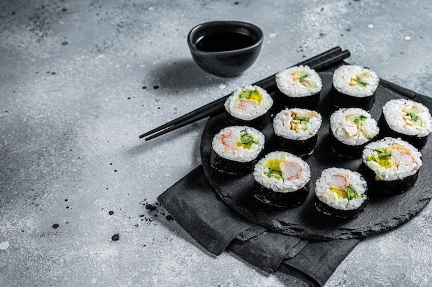 Korean style sushi Kimbap or gimbap made from steamed white rice Gray background Top view Copy space