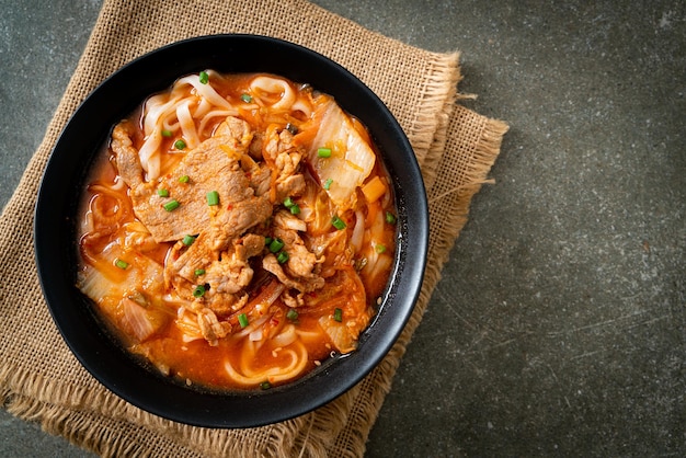 Korean udon ramen noodles with pork in kimchi soup