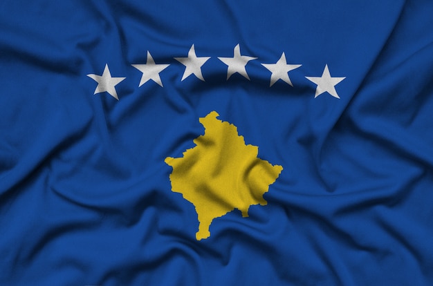 Kosovo flag  is depicted on a sports cloth fabric with many folds.