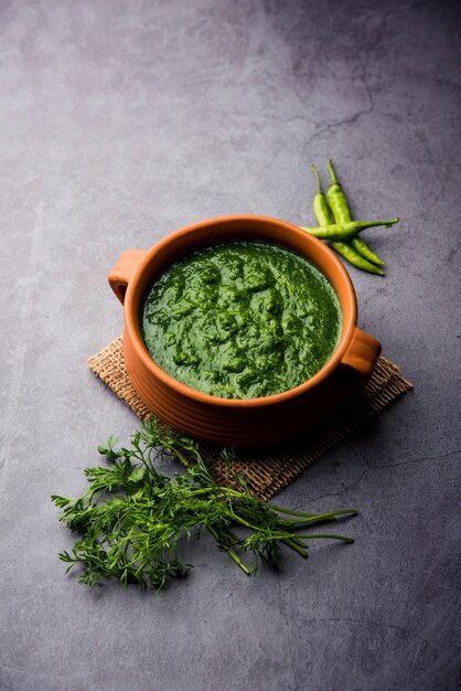 Photo kothimbir or dhaniya chutney made using cilantro or coriander with chilli, served in a bowl.