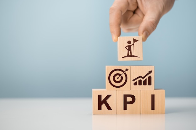 KPI Key Performance Indicator Businessman holds cube with KPI KPI key performance indicator increase optimisation business Business planning and measure success target achievement