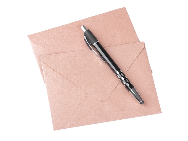 Kraft paper envelopes and a pen on a white isolated background. mail concept top view