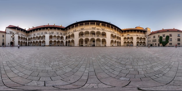 KRAKOW POLAND AUGUST 2022 full 360 hdri panorama on main square in Wawel Castle of old town with historical buildings temples and town hall with a lot of tourists in equirectangular projection