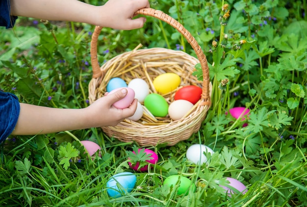 Krashenki homemade eggs in the basket and the hands of a child Selective focus