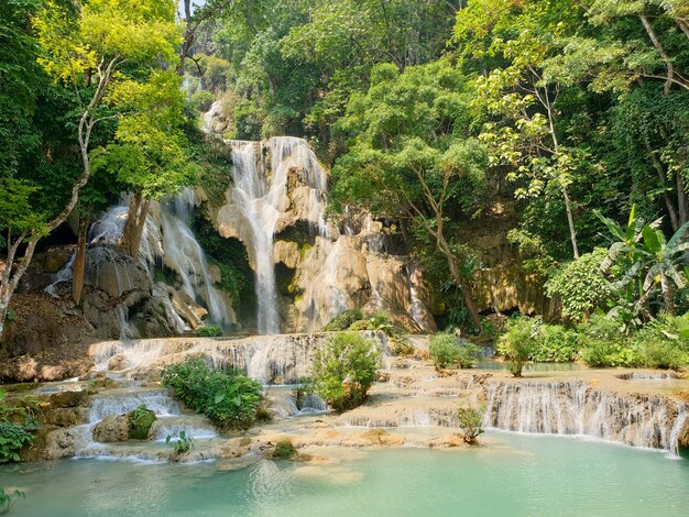 Photo kuang si waterfall stunning multitiered waterfall cascading into turquoise pools surrounded