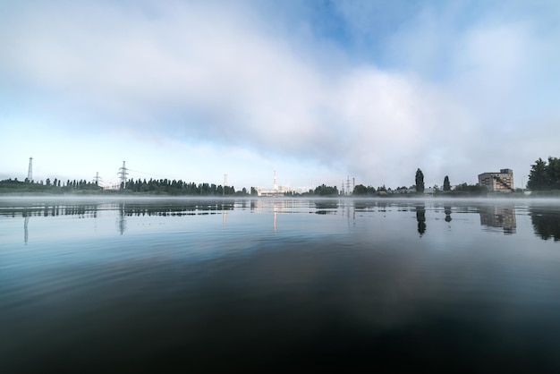 Kursk Nuclear Power Plant reflected in a calm water surface