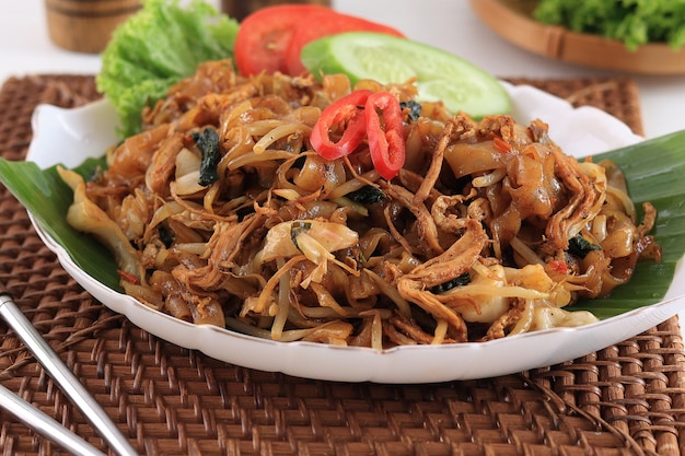 Photo kwetiaw or kwetiau fried rice flat noodles with chicken meatballs and various vegetables