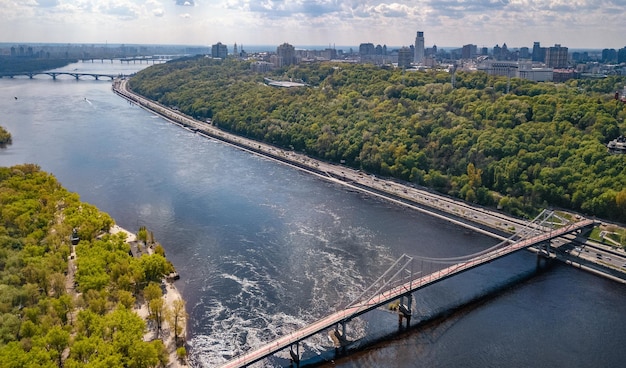 Kyiv city skyline and Dnipro river aerial drone view from above Kiev hills Park bridge Ukraine