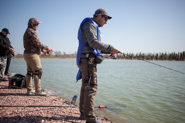 Kyiv, Ukraine April 16, 2018. Caucasian fisherman catches fish with a spinning rod on the lake.