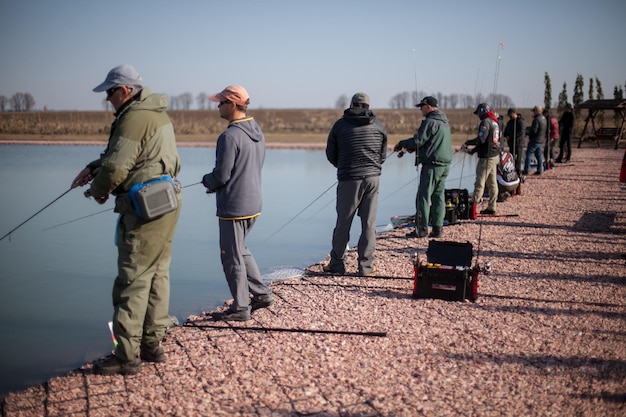 KYIV, UKRAINE - APRIL 16, 2018 Sport fishing tournament, male fishermen catch fish in the lake