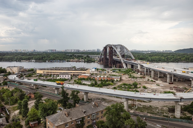 KYIV, UKRAINE - Jun 04, 2019: Construction of the Podolsky bridge in Kyiv. Construction of traffic artery. Construction of the bridge across the river