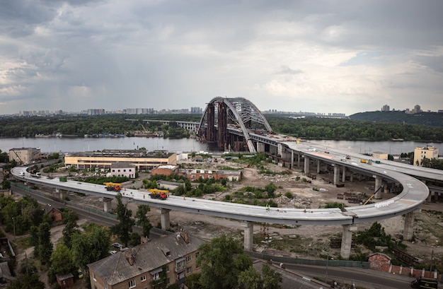 KYIV, UKRAINE - Jun 04, 2019: Construction of the Podolsky bridge in Kyiv. Construction of traffic artery. Construction of the bridge across the river