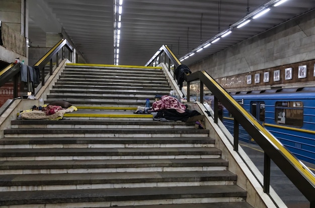 KYIV UKRAINE Mar 25 2022 War in Ukraine Subway station serves as a shelter for thousands of people during a rocket and bomb attack Sleeping area and selfmade bed on the floor of metro station