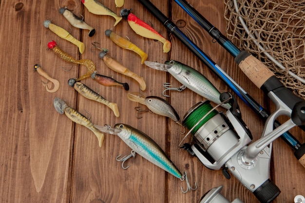 Kyiv Ukraine May 15 2019 Fishing tackle fishing spinning hooks and lures on wooden background with copy space