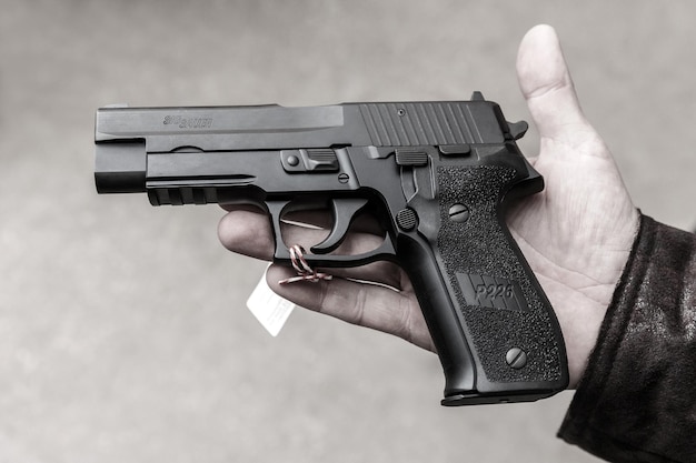 Kyiv Ukraine  october 20th 2020  Sig Sauer P226 handgun lying in a right male hand