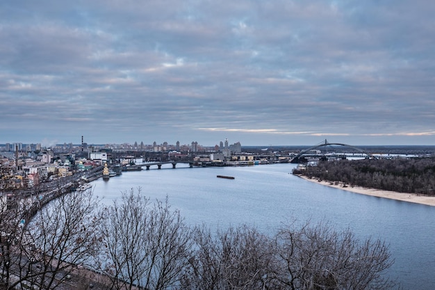 Kyiv, winter morning, beautiful view to the historical center Podol. Dnipro river, cloudy sky.