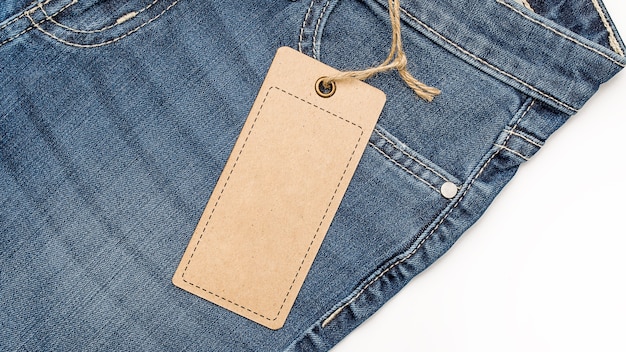 Label price tag mockup on blue jeans from recycled paper