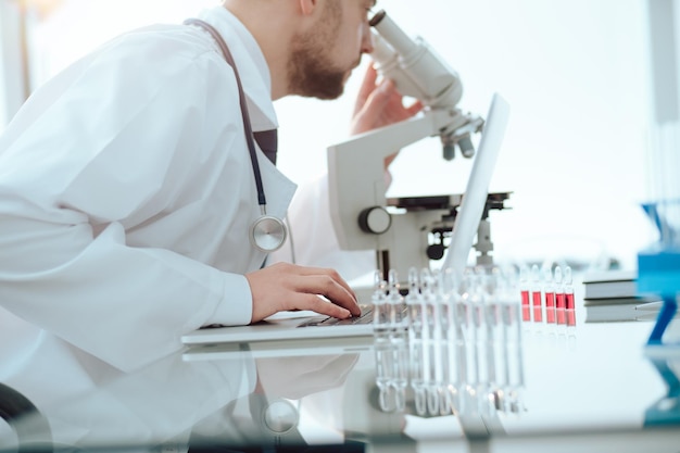 Laboratory assistant conducts testing in the laboratory. side view.