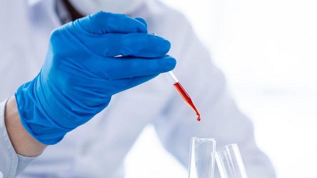 Laboratory assistants are investigating chemical reactions medical scientists chemical researchers chemical experiments and disease testing from patient blood samples Medicine and research concept