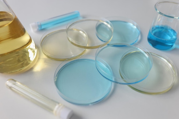 Laboratory glassware with colored liquids on lab table close up scientific research concept