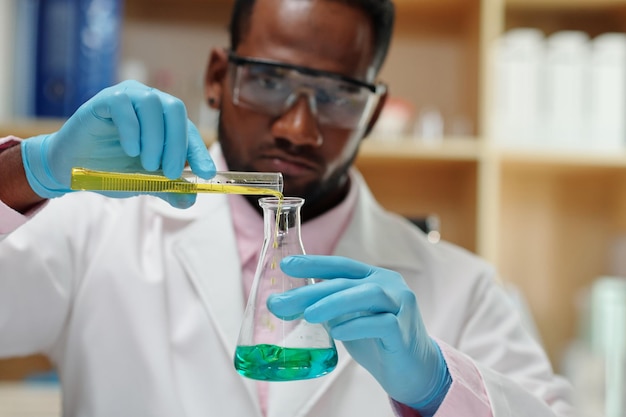 Laboratory Worker Mixing Liquids