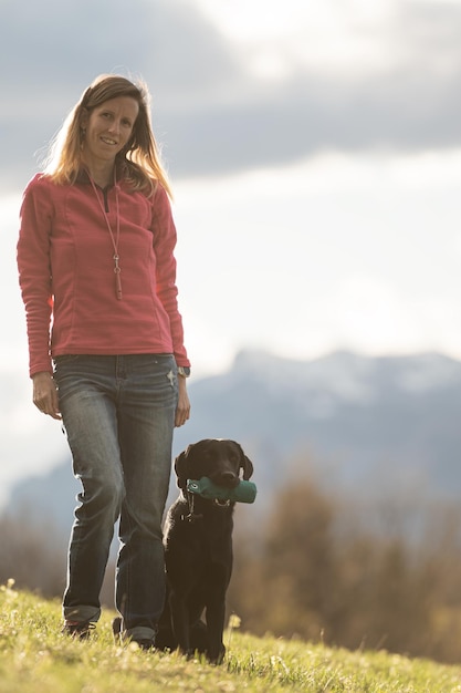 Labrador retriever dog sitting by her owner